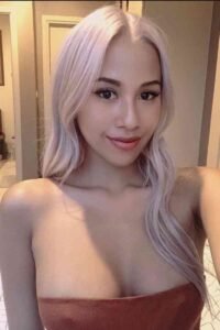 KL Escort Girl Woman with light pink hair and brown top Sex Service Malaysia