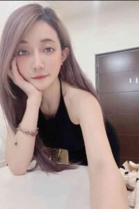 KL Escort Girl Attractive woman with lavender hair poses in a black dress. Sex Service Malaysia