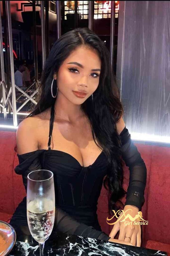 Stunning Asian woman in black dress with champagne. Incall/Outcall services available.