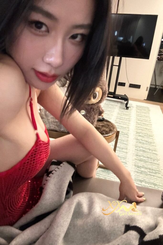 Asian woman in red dress, close-up portrait.