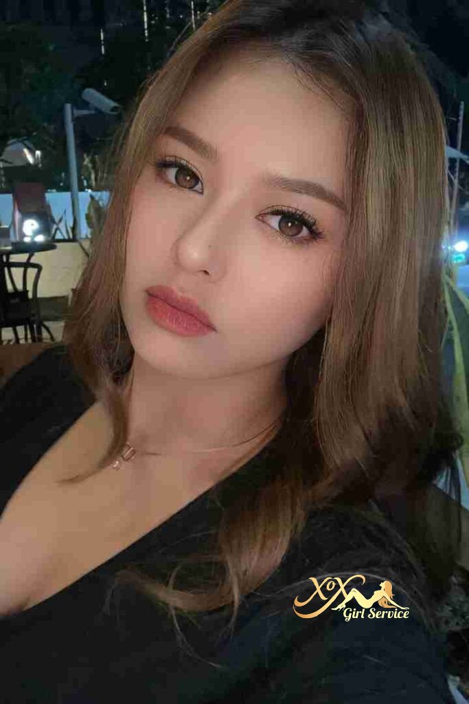 Beautiful Malay woman with soft glam makeup and brown hair.