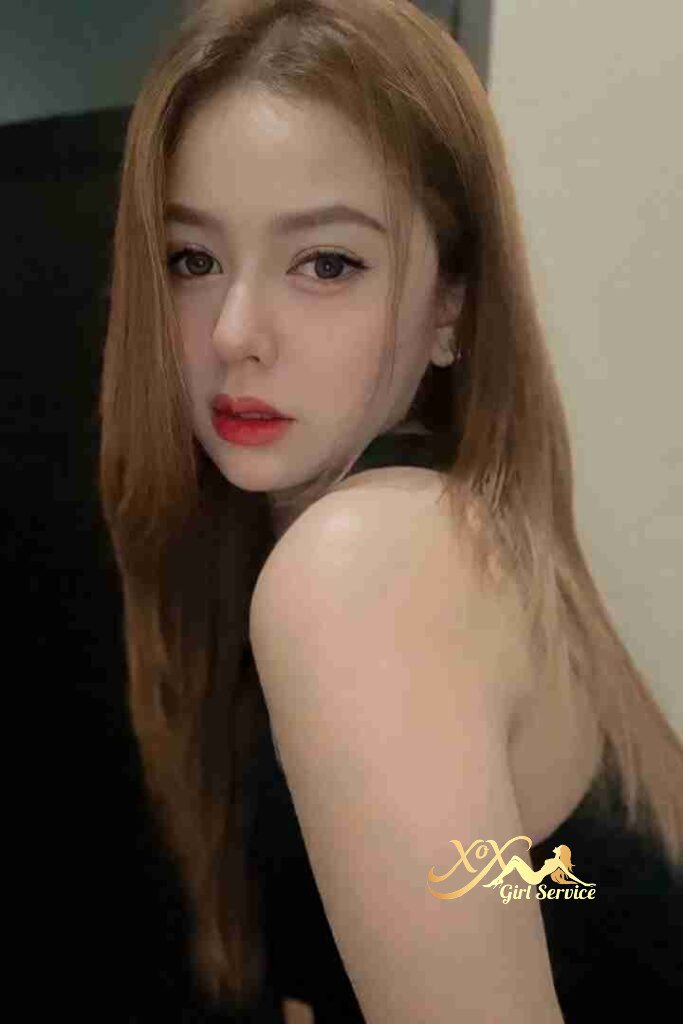 Beautiful Malay woman with red lipstick looking over shoulder. Tudung & Hijab style.