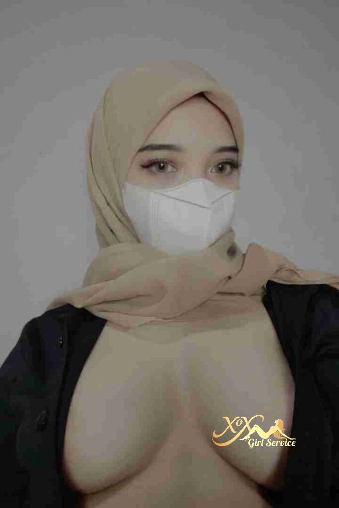 Malay woman in hijab and mask, cleavage visible.