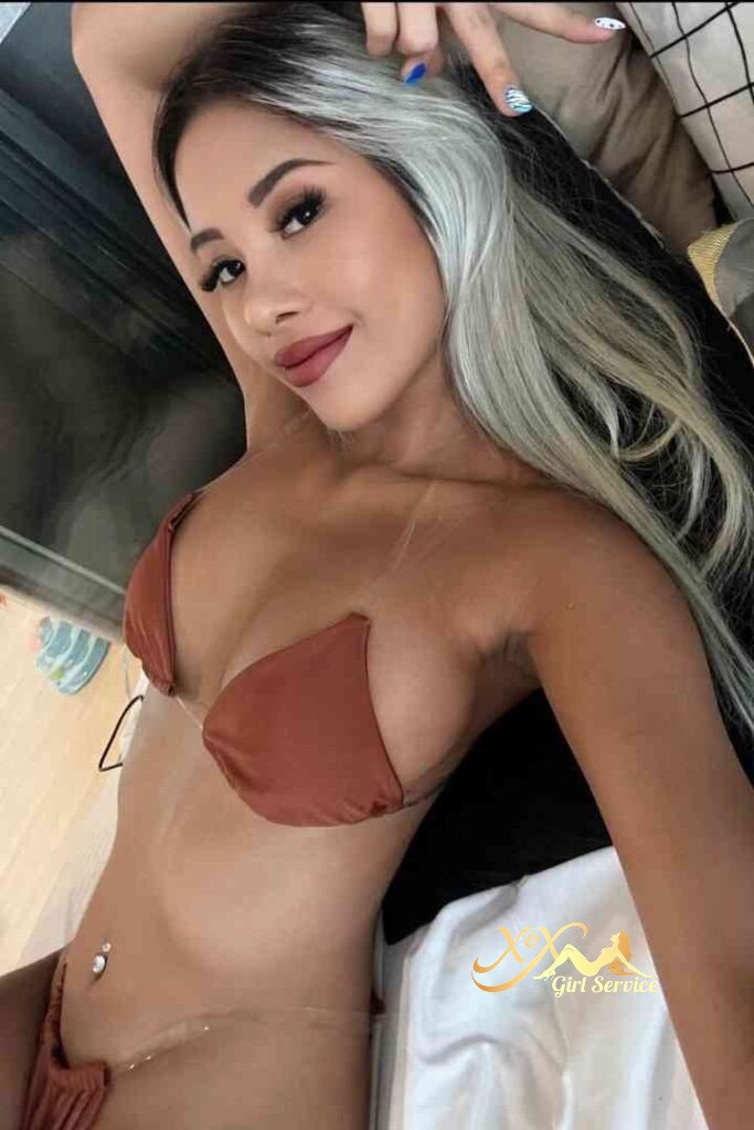 Bella, Thai escort in KL, lying down wearing brown bikini. Sensual incall outcall call girl.