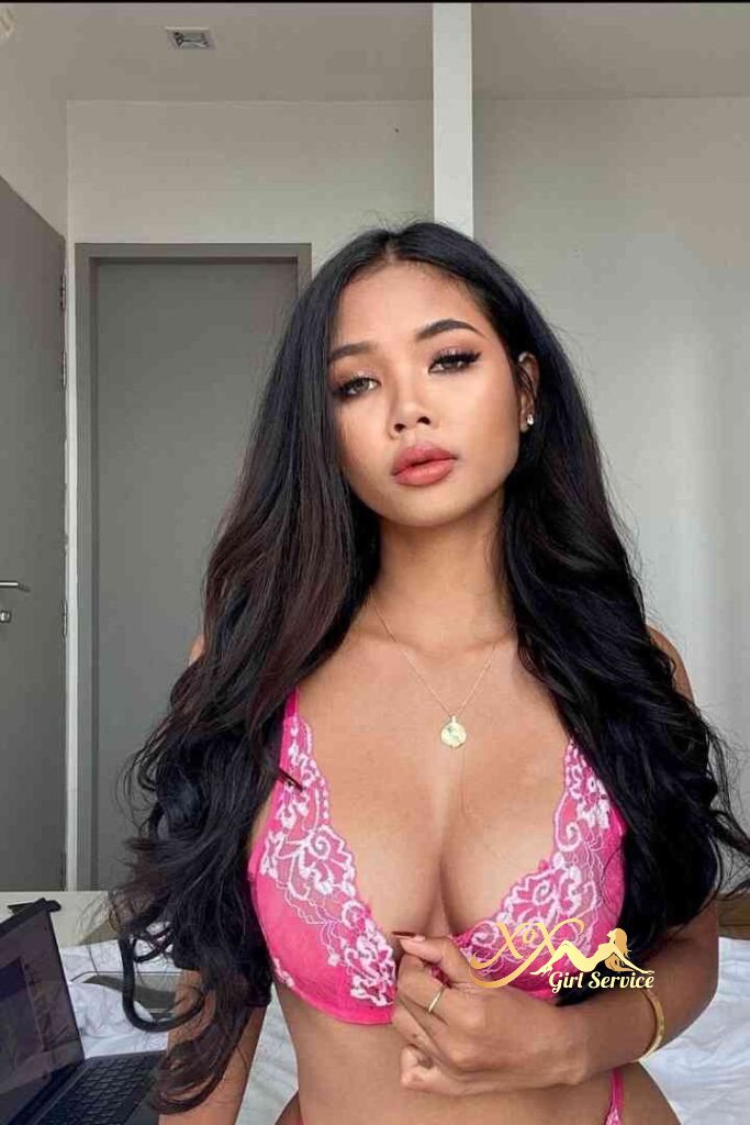 Seductive Thai C Cup Escort Vanessa in KL wearing pink lingerie. Long dark hair, gold necklace.