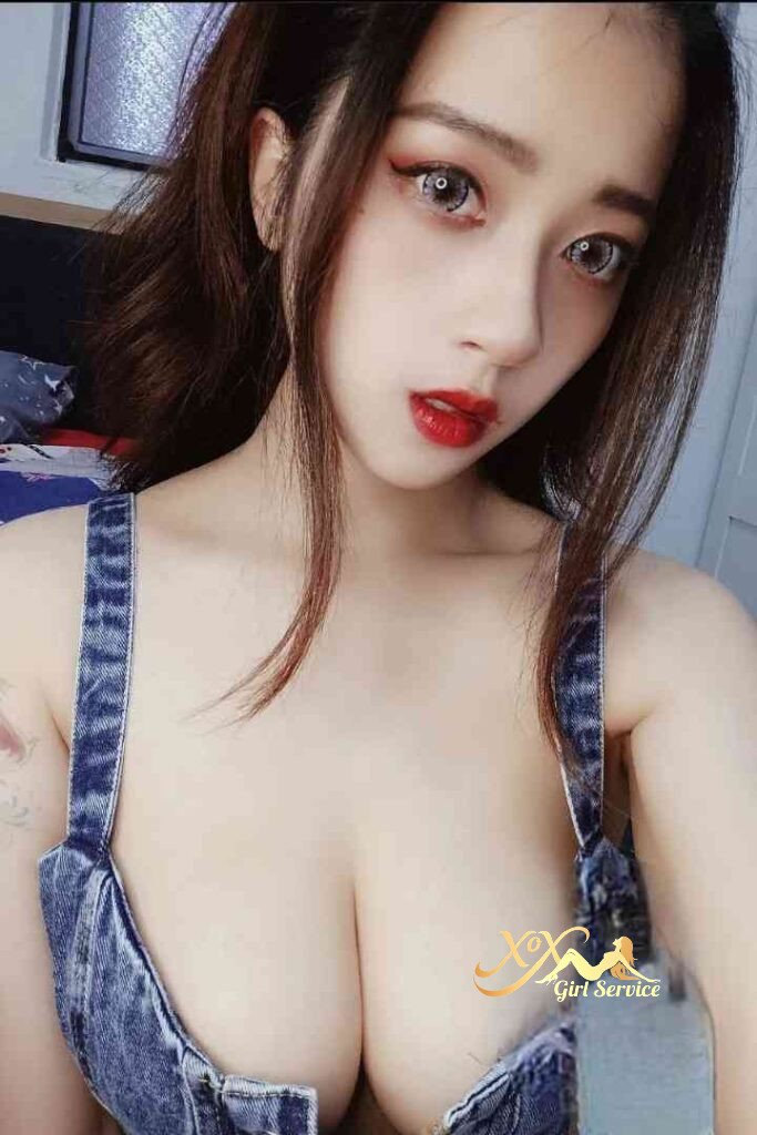 Beautiful Vietnamese woman with red lipstick and denim top. C cup boobs.