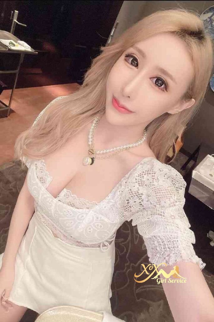 Vietnamese escort Windy in white dress with pearl necklace, KL escort services.